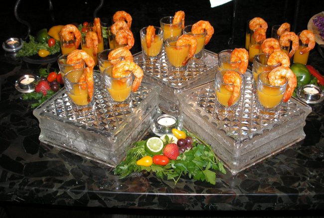 chileglazedmangoshrimp A display of shrimp and mango cocktails on ice.