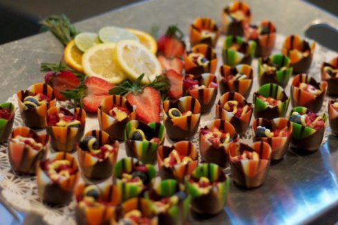 A table topped with lots of fruit covered in icing.