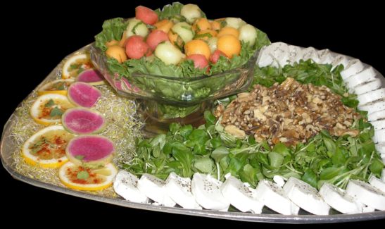 A platter of food with fruit and vegetables.