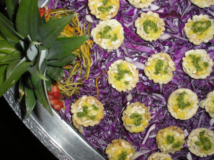 A tray of food with purple cabbage and green onions.
