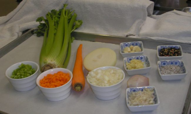 20110425_4 A table topped with bowls of vegetables and carrots.