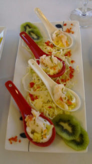 A tray of food with fruit and vegetables on it.