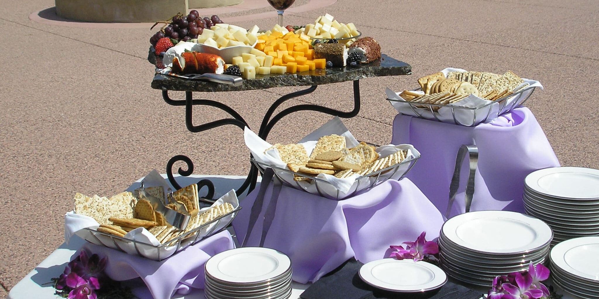 cheese-cracker-display A table with food on it and plates