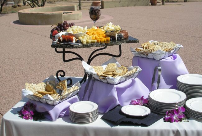 cheese-cracker-display A table with food on it and plates