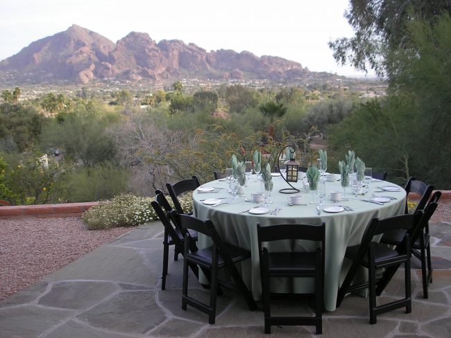 dinner-party-private-residence-1 A table set for dinner with mountains in the background.