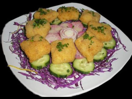 A plate of food with purple cabbage and cucumber.