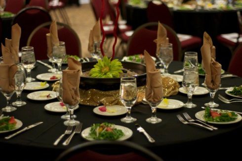 A table set with plates and silverware on it.