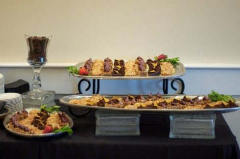 A buffet with two trays of food on it