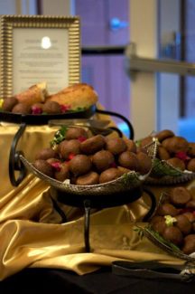 A table with food on it and gold cloth