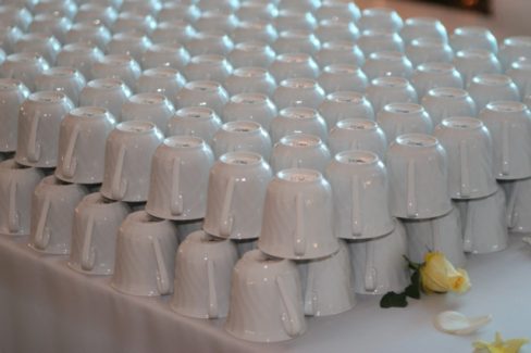 A table covered in cups on top of it.