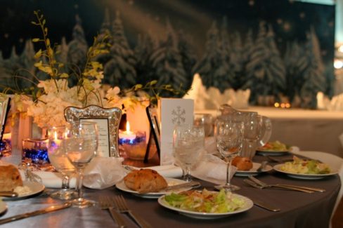 A table set with plates and glasses for dinner.