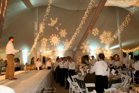 A group of people standing around a table.