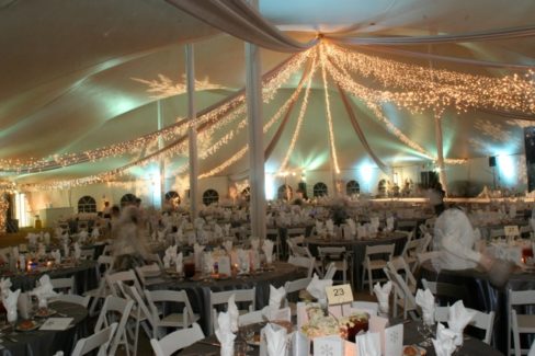 A large tent with many tables and chairs